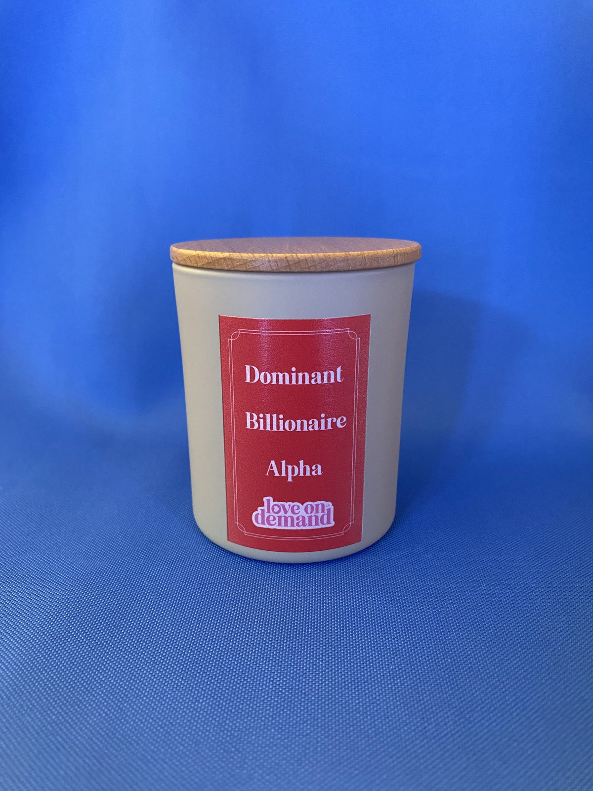 Candle jar with a red label on a blue background