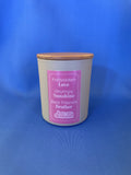 Candle with a pink label on a blue background