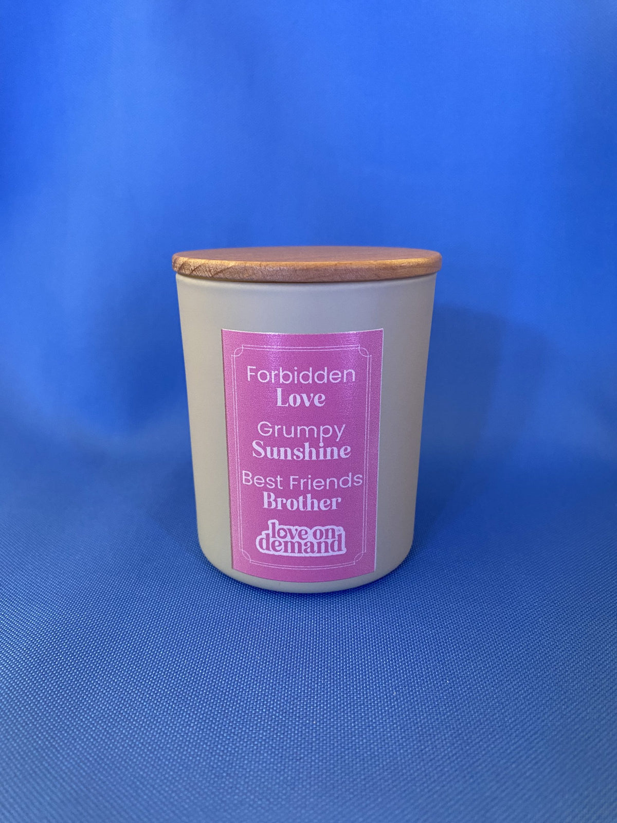 Candle with a pink label on a blue background
